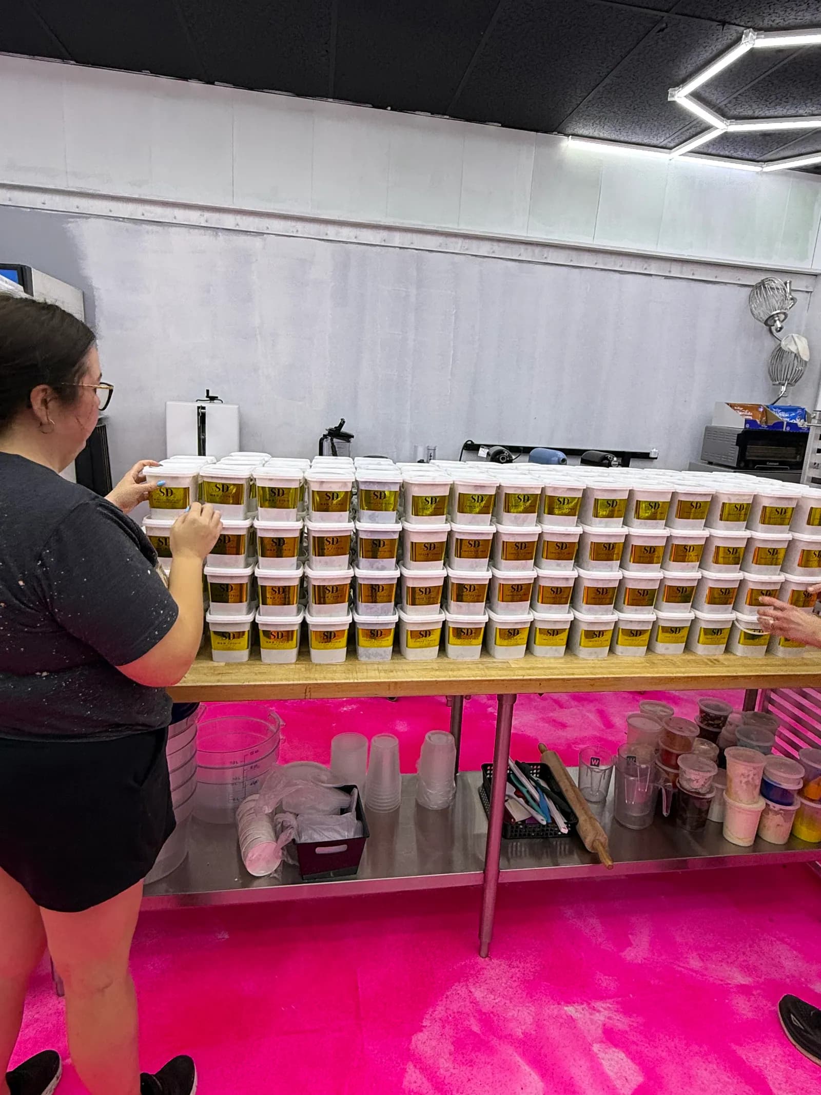 Sweet Delights team preparing and labeling fundraiser cookie dough tubs